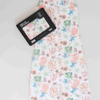 Dreamy days baby dream swaddle pink coral with black packaging on white surface