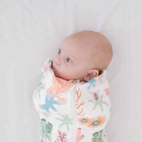 Dreamy days baby dream swaddle pink coral on white surface