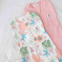 Dreamy days baby dream swaddle pink and coral on white surface