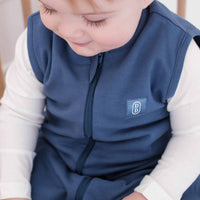 Toddler wearing a dreamy days navy dream sack in cot