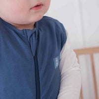 Toddler wearing a dreamy days navy dream sack in cot