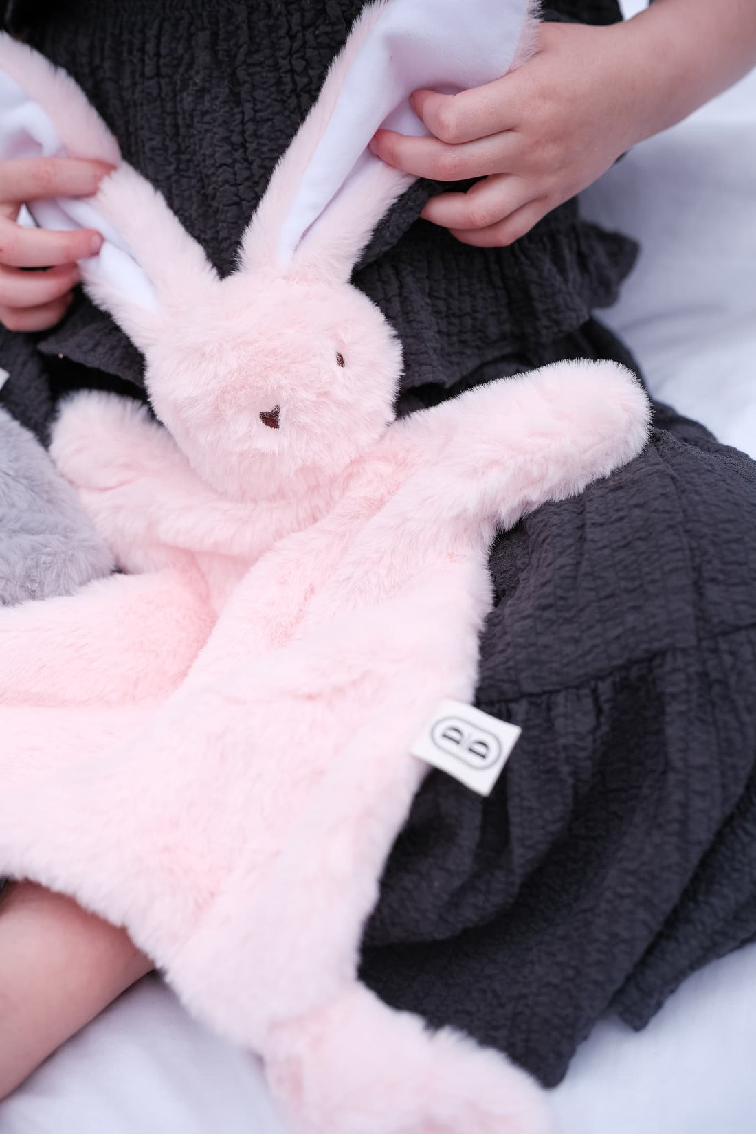 Dreamy days pink bunny comforter on Childs lap