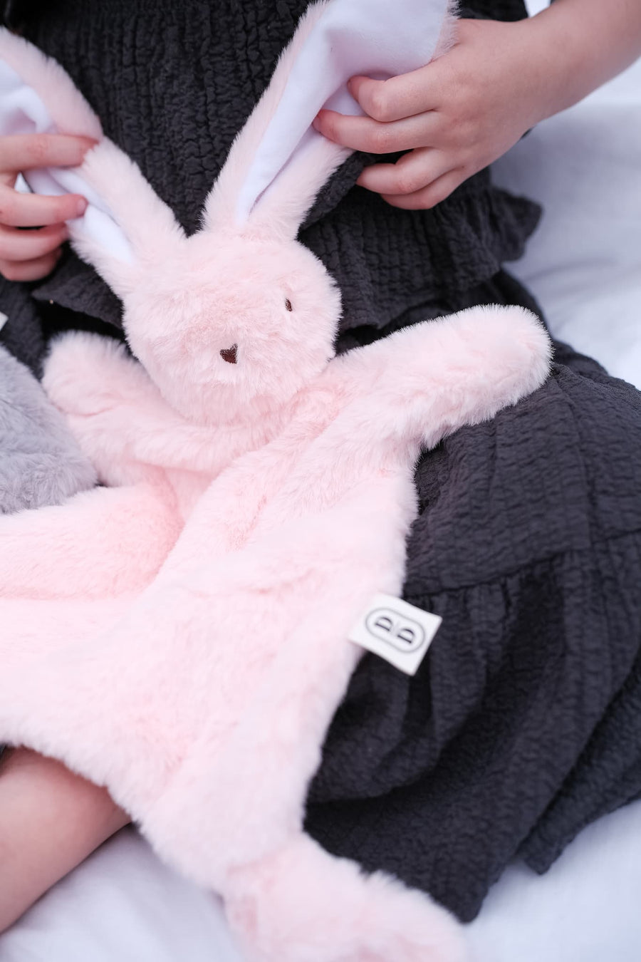 Dreamy days pink bunny comforter on Childs lap