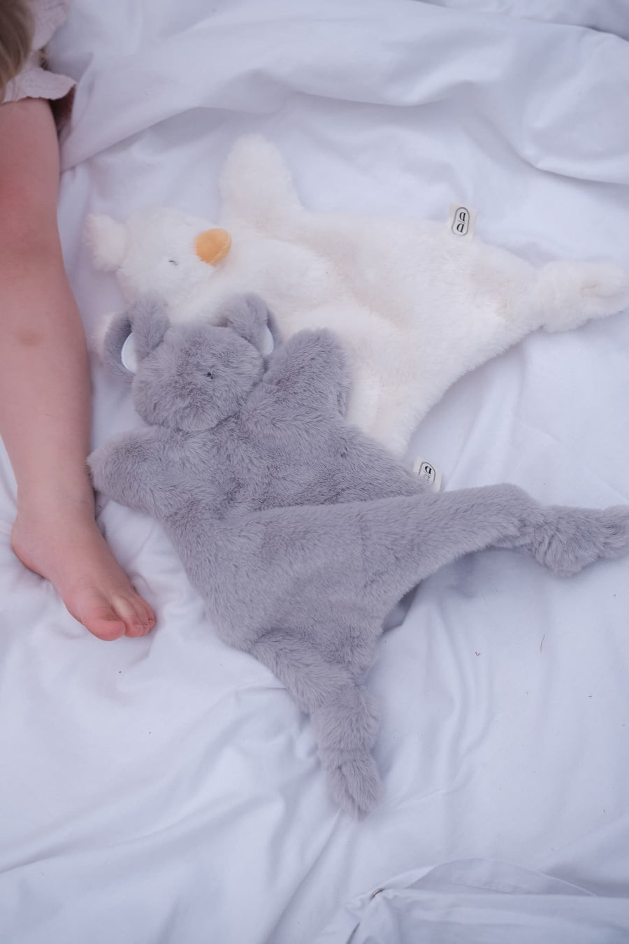 Dreamy Days white goose and grey mouse plush comforter on white blanket