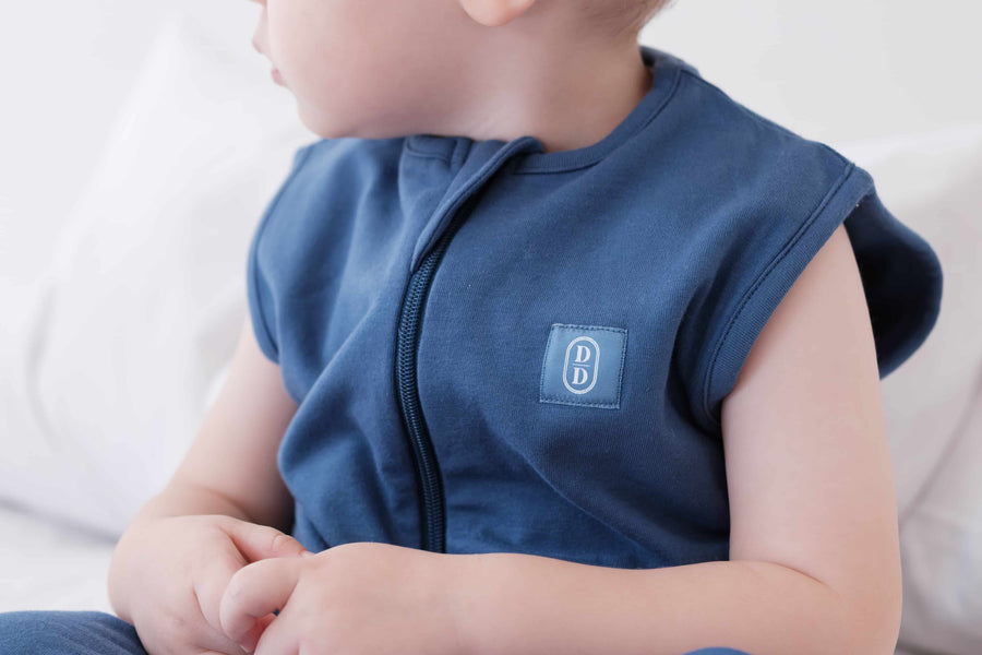 Toddler wearing a dreamy days navy dream sack 